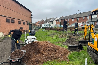 Members of Deane & Derby Cricket Club digging and improving their community garden, funded by the Green Spaces Fund